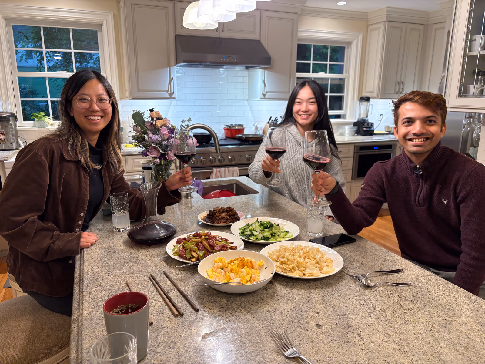 Arbor teammates sharing a family-style dinner around a kitchen island
